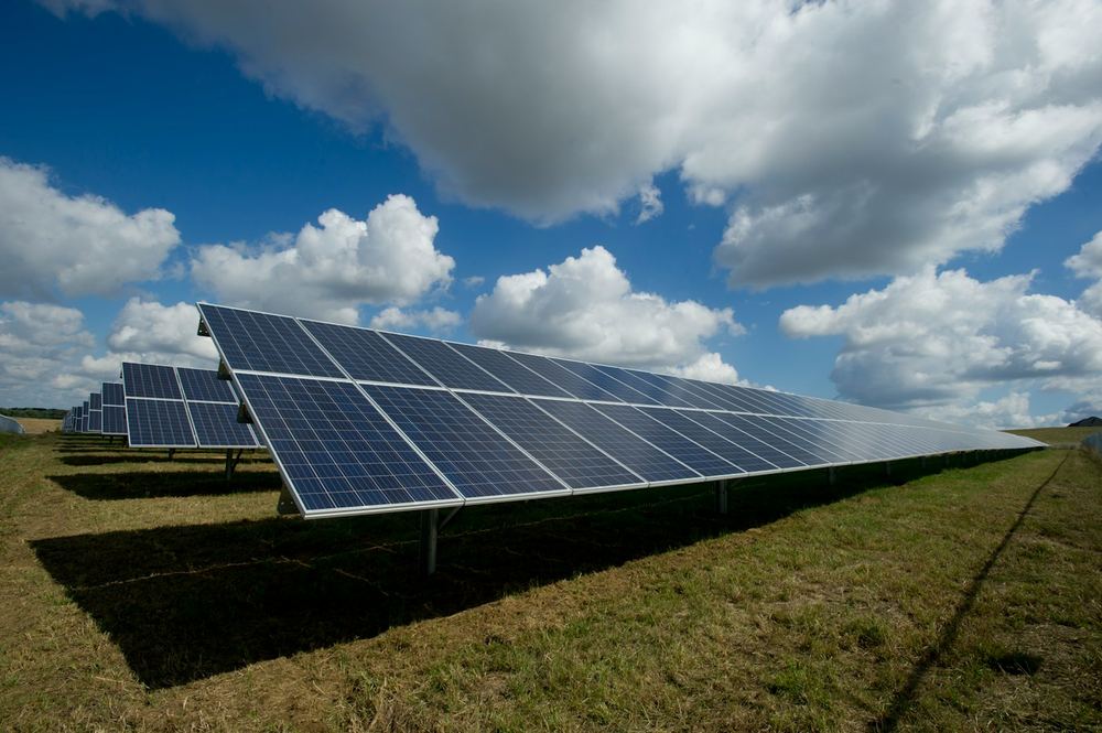 Solar panels installed on a green field